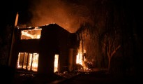 A house burns in Varnava village during a wildfire, north of Athens, Greece, Sunday, Aug. 11, 2024. Many regions of the country are on high alert due to high temperatures and winds. (AP Photo/Michael Varaklas)