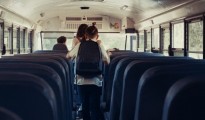 Energetic pupils leave academic shuttle. Friendly crowd go out school bus. Diverse multicultural students running out vehicle after studies. Professional driver sitting alone. Transport concept.