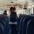 Energetic pupils leave academic shuttle. Friendly crowd go out school bus. Diverse multicultural students running out vehicle after studies. Professional driver sitting alone. Transport concept.